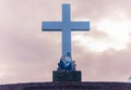 Large Cross Monument with Religious Statue at Sunset Royalty Free Stock Photo