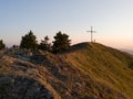 Large cross at the top of Gostilj on the mountain Ozren at evening