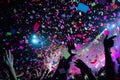 A large crowd of people enthusiastically enjoying a concert while colorful confetti fills the air, A burst of confetti rains down Royalty Free Stock Photo