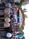 A large crowd of people gathered near the stage in the Park watching the performance of artists
