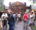 a large crowd of people tourists gathered waiting for a tour