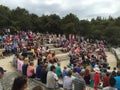 A large crowd sitting waiting for the eurption of the local geyser at thermnal springs near Rotorua