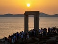 A large crowd of tourists around the famous Portara of Naxos