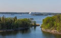 Large cruise liner swims between picturesque islands Royalty Free Stock Photo