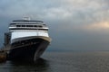 Large cruise ship anchored in the old port during a cloudy summer sunrise Royalty Free Stock Photo