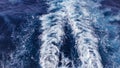 Large cruise ship wake leaving a foamy trail in the deep blue sea. Royalty Free Stock Photo