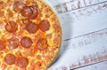 Large crust pizza with mozzarella, salami, pepperoni, and cheddar cheese Royalty Free Stock Photo