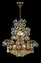 Large crystal chandelier in baroque style isolated on black background.