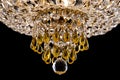 Large crystal chandelier detail isolated on black background. Royalty Free Stock Photo