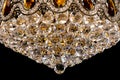 Large crystal chandelier detail isolated on black background. Royalty Free Stock Photo