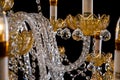 Large crystal close-up chandelier with candles isolated on black background. Royalty Free Stock Photo