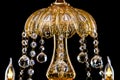 Large crystal close-up chandelier with candles isolated on black background. Royalty Free Stock Photo