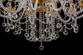 Large crystal close-up chandelier with candles isolated on black background. Royalty Free Stock Photo