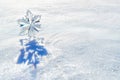 Large Crystal Snowflake Ornament Glistening in the Snow Royalty Free Stock Photo