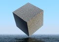 large cube hanging above the ocean