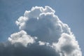 A Large Cumulus Cloud In A Blue Sky With Cirrus Clouds.