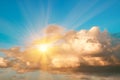 Large cumulus storm clouds and sun in the blue sky