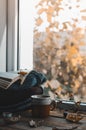 Large Cup of cappuccino on vintage brown background. Autumn, fall leaves, hot steaming cup of coffee and a warm scarf on wooden ta Royalty Free Stock Photo