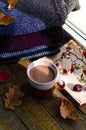 Large Cup of cappuccino on vintage brown background. Autumn, fall leaves, hot steaming cup of coffee and a warm scarf on wooden ta Royalty Free Stock Photo