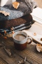 Large Cup of cappuccino on vintage brown background. Autumn, fall leaves, hot steaming cup of coffee and a warm scarf on wooden ta Royalty Free Stock Photo