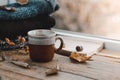 Large Cup of cappuccino on vintage brown background. Autumn, fall leaves, hot steaming cup of coffee and a warm scarf on wooden ta Royalty Free Stock Photo