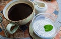 A large Cup of coffee, Chia pudding on coconut milk with a mint leaf and cream in a milk jug on the table Royalty Free Stock Photo
