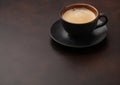 Large cup of fresh hot coffee with creamy foam on brown background