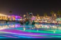 A large decorative dragon climbs out of an illuminated pond in the Global Village near Dubai city, United Arab Emirates
