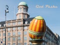 A large decorative Easter egg against a building in the city of Copenhagen and text in danish - Happy Easter. Royalty Free Stock Photo