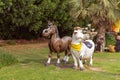 Large decorative fabulous figures of a cow and a horse stand near the entrance to the botanical Dubai Miracle Garden in Dubai city