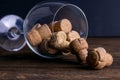 Large decorative glass tumbler, wine glass on a long stem, beautiful filled with wine corks lies on a wooden table. Corks are Royalty Free Stock Photo