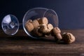 Large decorative glass tumbler, wine glass on a long stem, beautiful filled with wine corks lies on a wooden table. Corks are Royalty Free Stock Photo