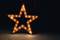 Large decorative retro star with lots of burning lights