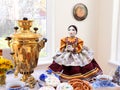 A large decorative tea warmer in a form of a doll in traditional Russia dress holding tea cup