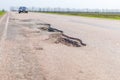 Large deep pothole an example of poor road Royalty Free Stock Photo