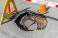 A large, deep pothole in a road Royalty Free Stock Photo