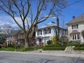 large detached houses with front yards with mature trees