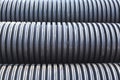 Large diameter black polypropylene pipes for laying communications, drainage systems and heating mains under the road. Modern