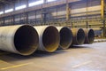 Large diameter pipes are stacked in an industrial factory shop Royalty Free Stock Photo