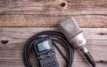 Large diaphragm condenser studio microphone Neumann tlm 103 and Zoom H5 recorder on a wooden background.