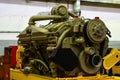 Large diesel engine with a huge turbine in the warehouse of finished products factory