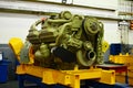 Large diesel engine with a huge turbine in the warehouse of finished products factory for the production of large mining trucks. Royalty Free Stock Photo