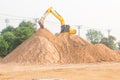 Large diesel mechanical excavator digging earth machine at excavation working in road construction