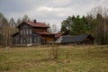 Large, dilapidated wooden house in a forest glade