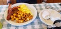 The large diner breakfast of scrambled eggs, bacon, sausage, Hashbrowns, and biscuits and gravy