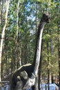 Large dinosaur figure in street outdoor park. museum of ancient extinct dinosaurs outside in the forest. jurassic park museum Royalty Free Stock Photo