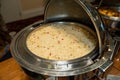 large dish of rice pilaf with red and green peppers sprinkled throughout at a corporate event provided by caterers