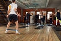 Large diverse group of people doing aerobics exercises in a class in a gym in a health and fitness concept Royalty Free Stock Photo