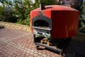 Large domed red metal outdoor pizza oven. Royalty Free Stock Photo