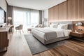 Large double bed in modern hotel room, in light colors